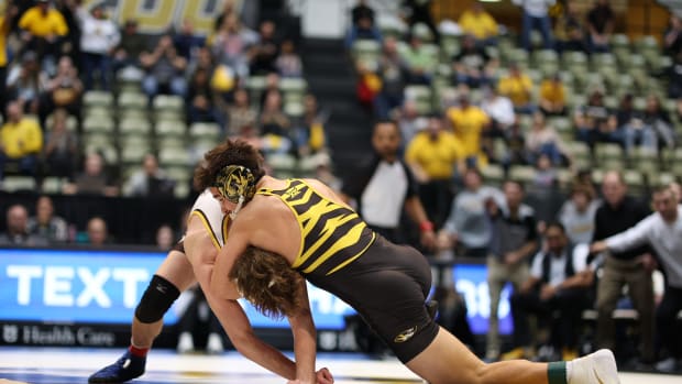 Nate Pulliam (149) defeats No. 23 Wyoming redshirt sophomore Gabe Willochell in a major decision, 21-10.